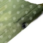 Close-up of the drainage grommet at the bottom of the CamelBak MOLLE Hydration Carrier, designed to prevent water retention.