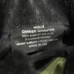 Internal label of the CamelBak MOLLE Hydration Carrier featuring NSN 8465-01-465-2131 and manufacturer details.