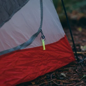 Ni Glo Gear Marker attached to tent zipper for nighttime visibility camping gear locator